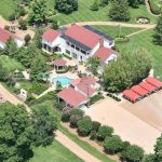 Aerial view of Dolly Parton's estate with pool and red-roofed outbuildings